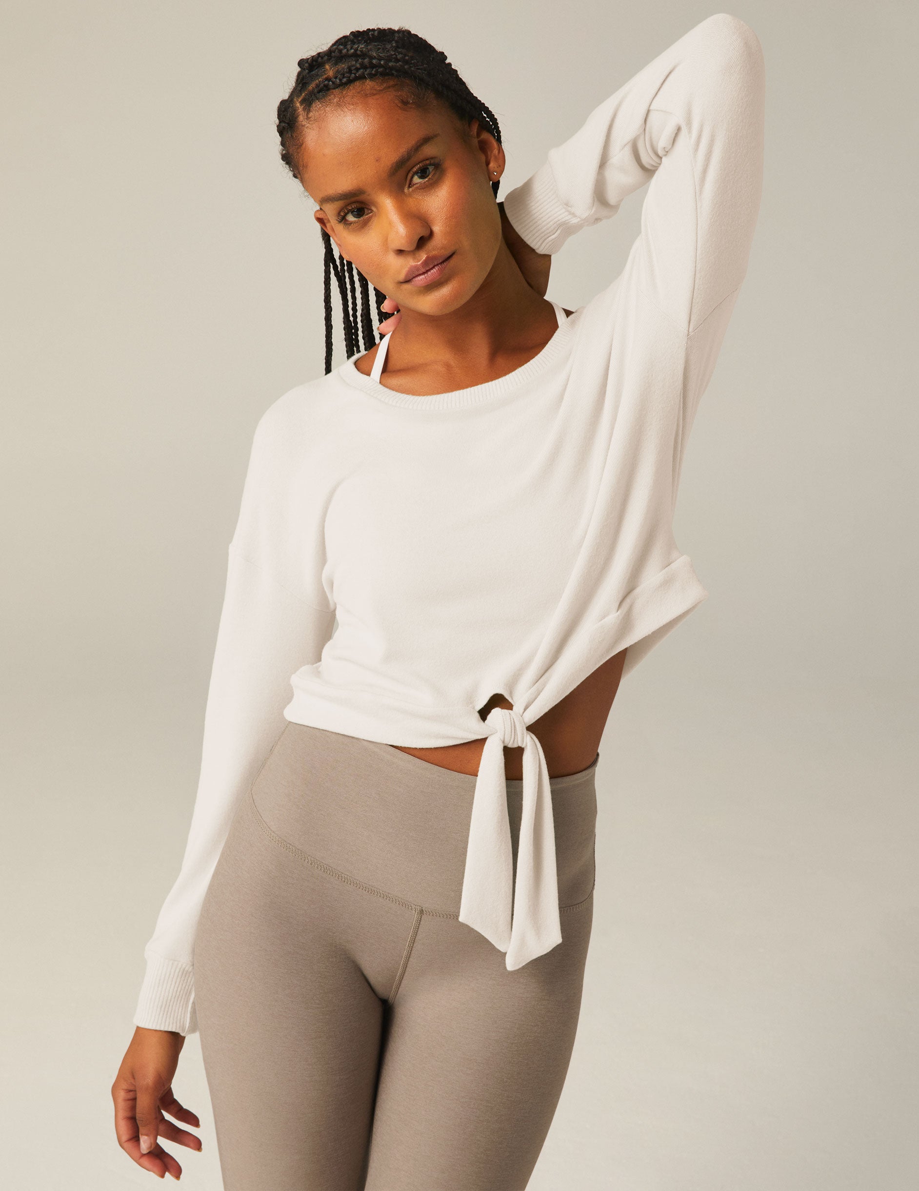 white scoop neck cropped pullover with a front tie detail. 