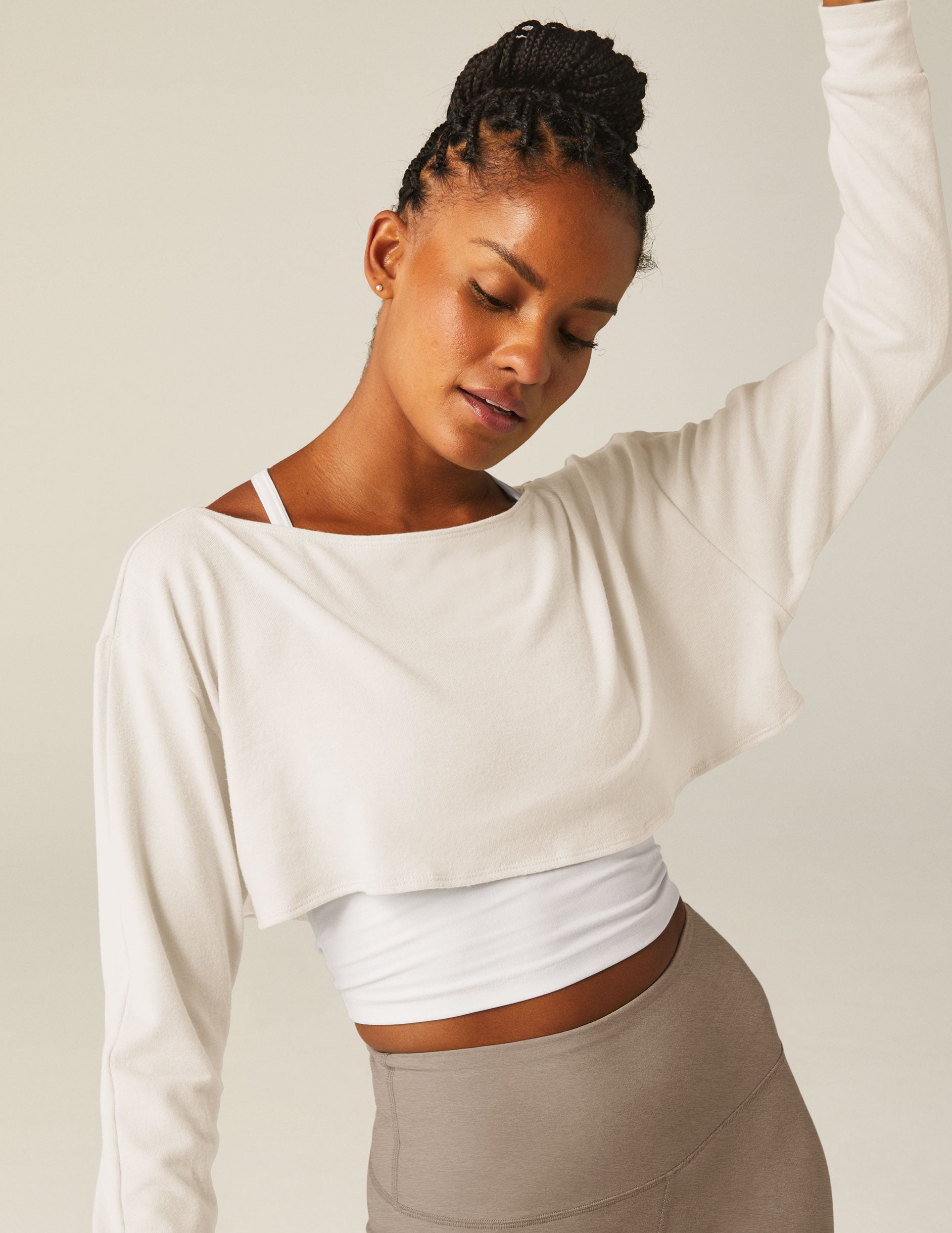 white off the shoulder shrug long sleeve top with a key hole detail. 