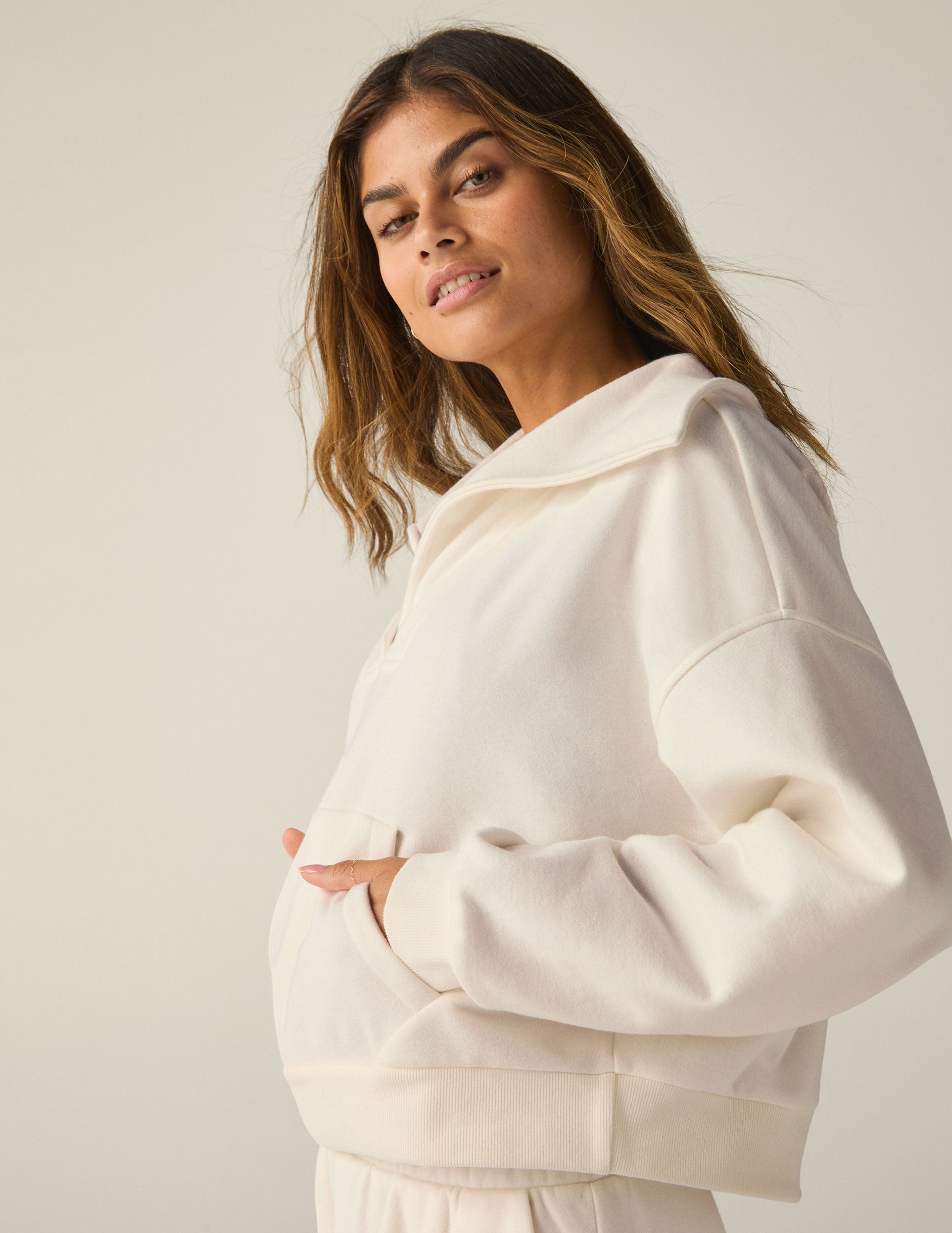 white pullover sweatshirt with a collar and kangaroo pocket. 