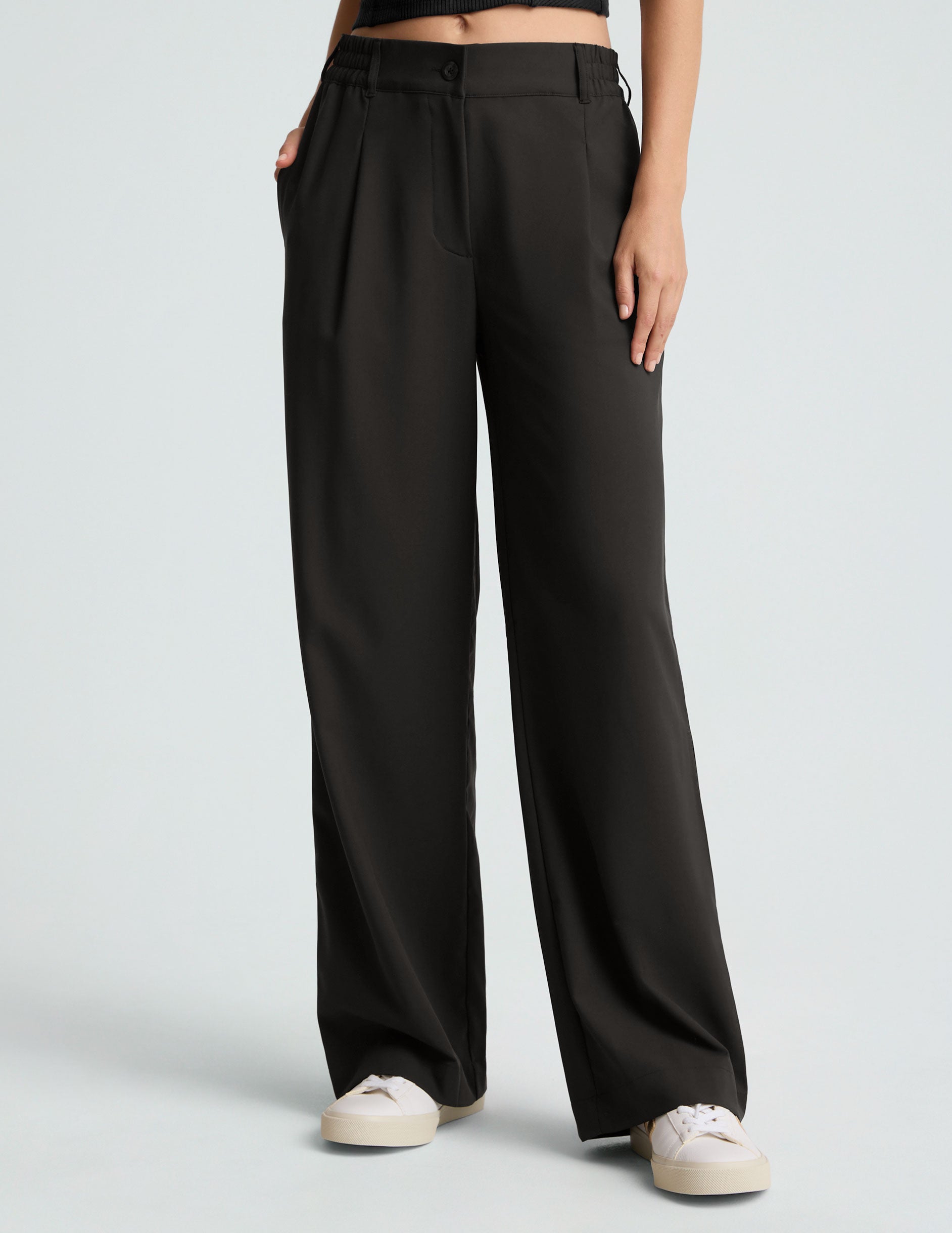 black mid rise jetstretch woven pants with cargo style pockets. 