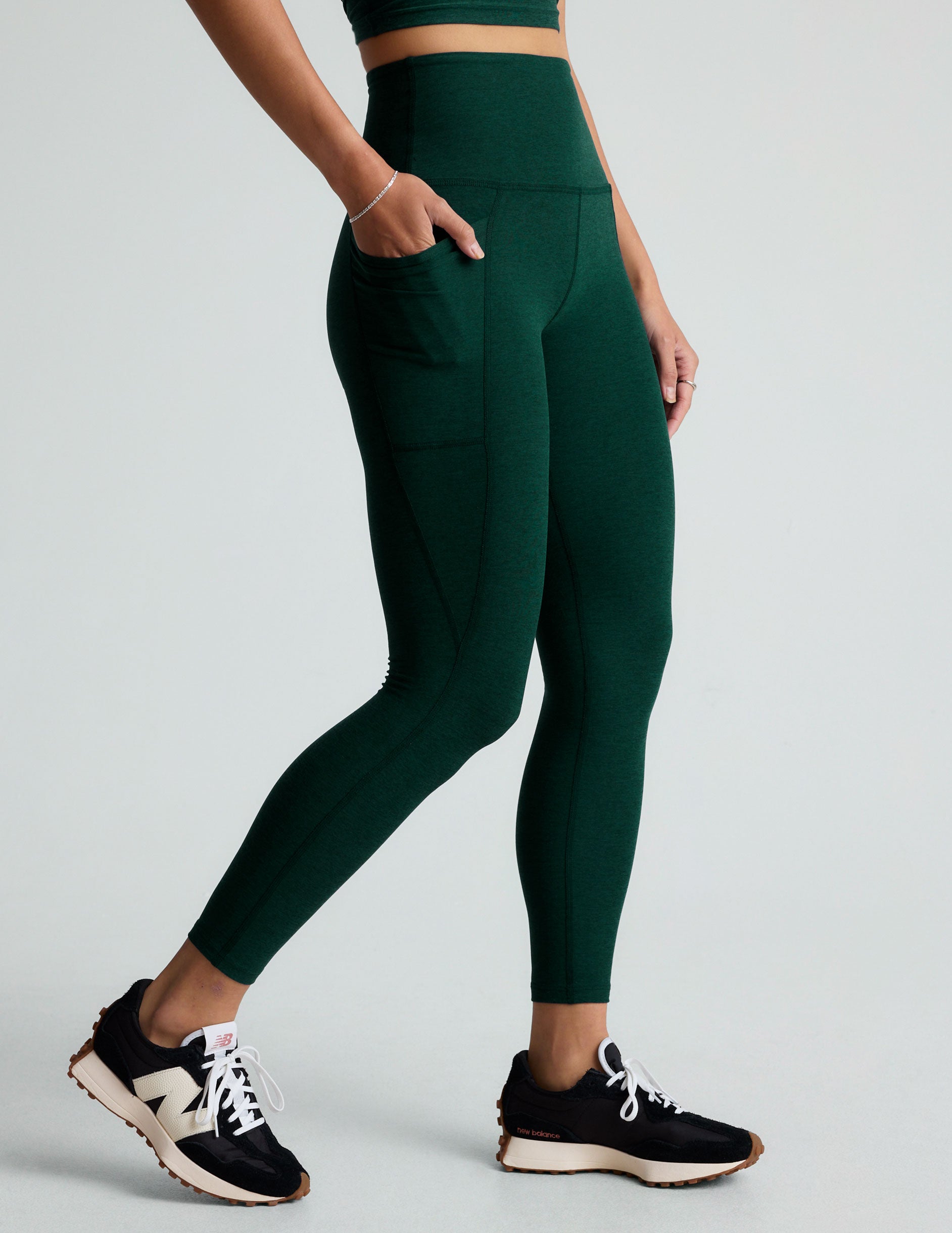 green high-waisted midi leggings with side pockets. 