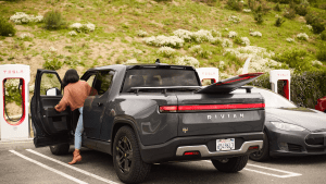 Rivian R1T at a Tesla Supercharger station