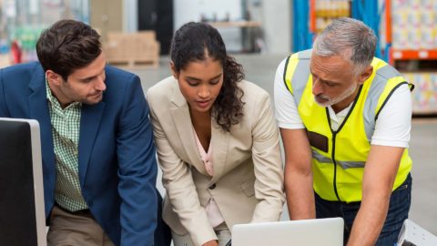 warehouse managers and worker with laptop