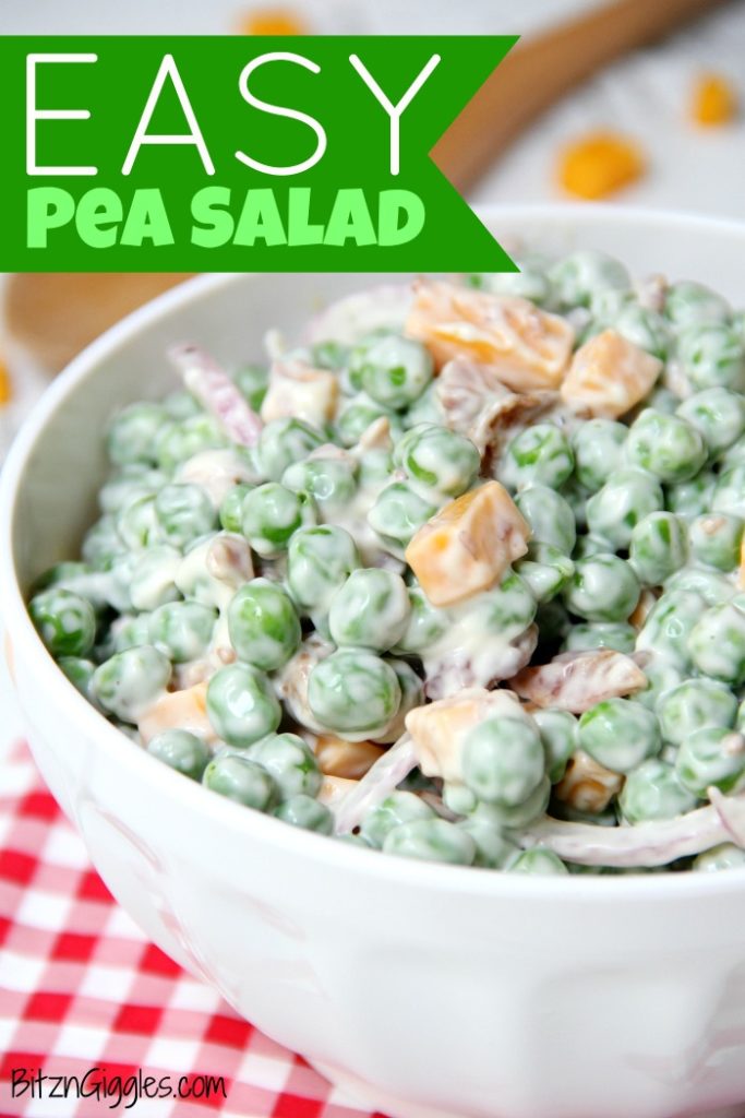 Creamy pea salad with cheese cubs in a white bowl.