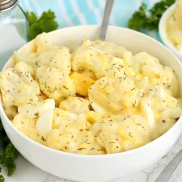 big white bowl of potato salad made with cauliflower