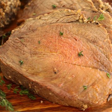 sliced pieces of prime rib on wooden cutting board