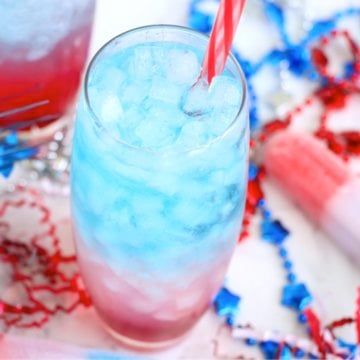 Red, white and blue drink surrounded by patriotic party favors.