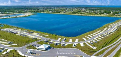 Aerial view of lake surrounded by RV park.