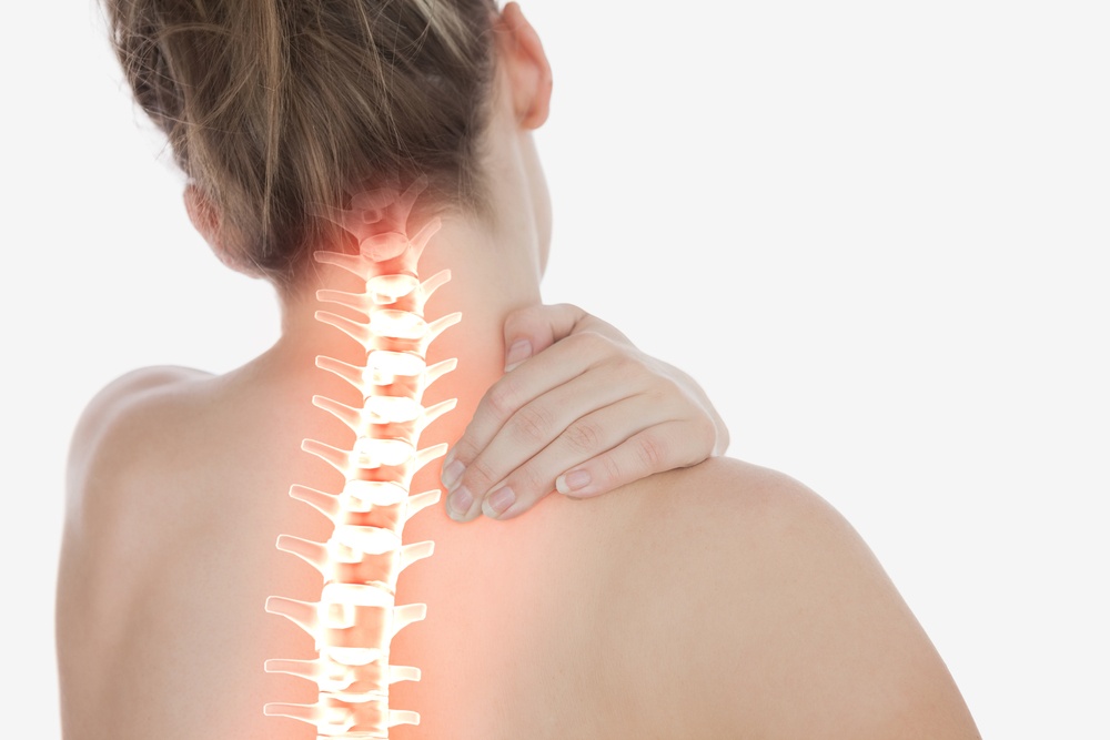 Digital composite of Highlighted spine of woman with neck pain