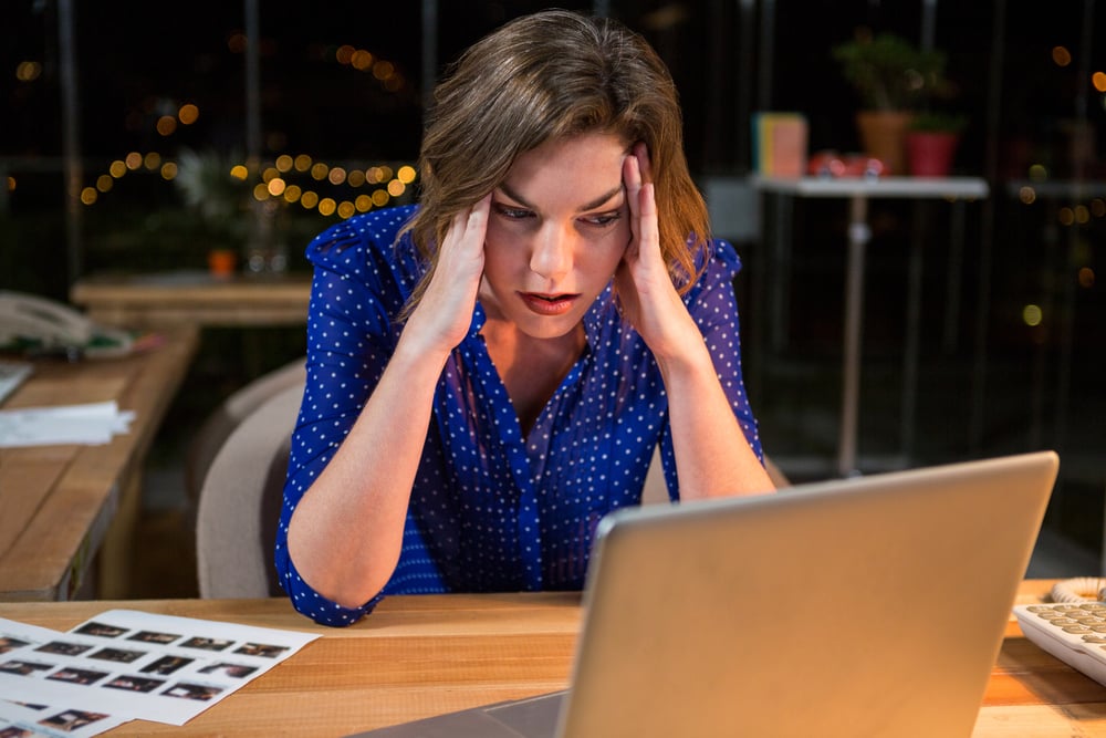 Stressed businesswoman sitting at her desk in the office-1