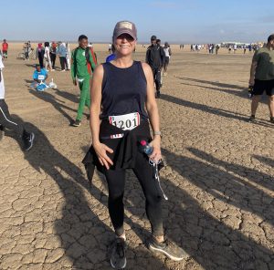 Female runner amid other runners