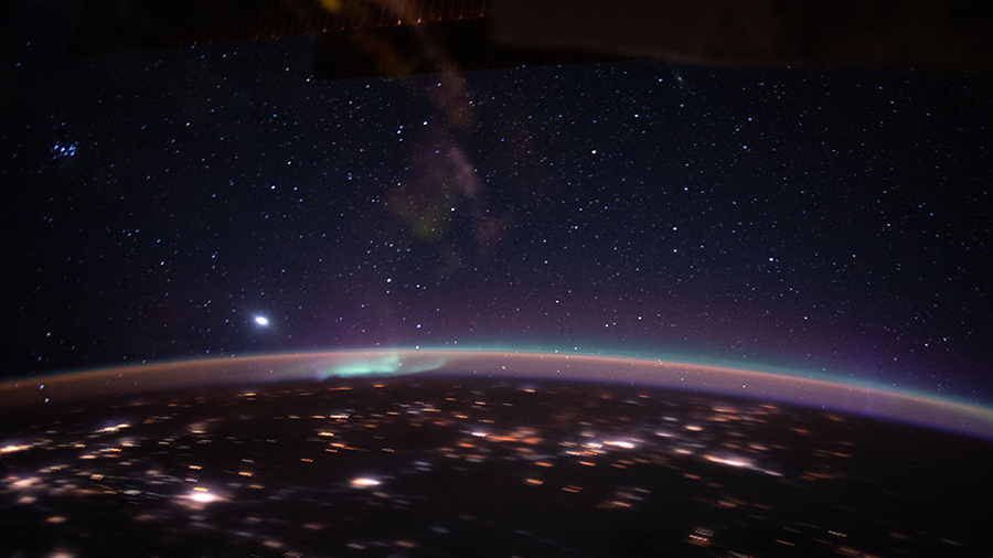 An aurora accents Earth's atmospheric glow