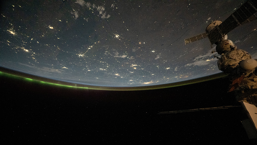 The city lights of central Asia and an aurora crowning Earth's horizon are pictured from the International Space Station as it orbited above western Kazakhstan.