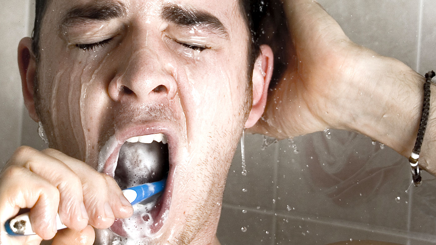 Man brushing in shower