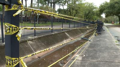 Caution tape blocks a 20 ft. gap in the broken fence