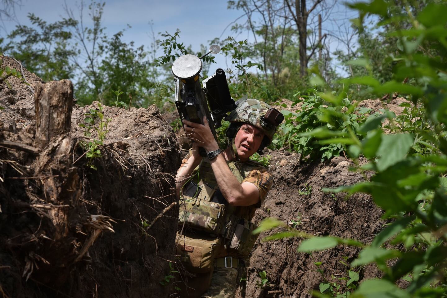 A Ukrainian serviceman carries a US Stinger air-defense missile launcher on the front line in the Zaporizhzhia region of Ukraine, on May 28.