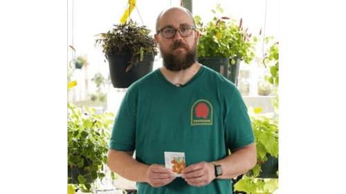 A Buchanan's Plants associate holds a bag of seeds