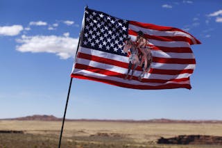 A U.S. flag flies next to a roadside  jewellery stand on the Navajo Reservation, by a remote section of the Grand Canyon near Li