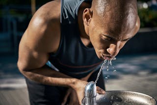 Male athlete drinking water