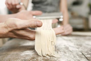 Germany, Cologne, Man and woman making pasta