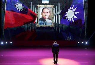 Taiwan's ruling Nationalist Kuomintang Party (KMT) chairman and presidential candidate Chu bows to Taiwan's national flag, KMT's