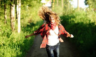 happy teenager girl in red shirt walking