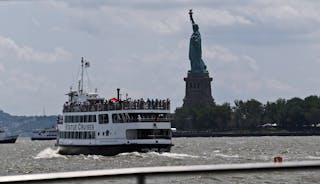 People arrive from lower Manhattan to the Statue of Liberty during its reopening to the public in New York