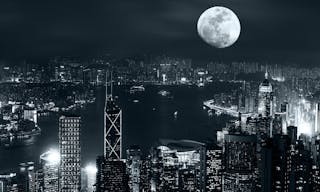 Night aerial view panorama of Hong Kong skyline at full moon night under cloudy sky