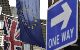 A British Union flag and a European Union flag hang from a building in central London