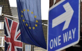 A British Union flag and a European Union flag hang from a building in central London