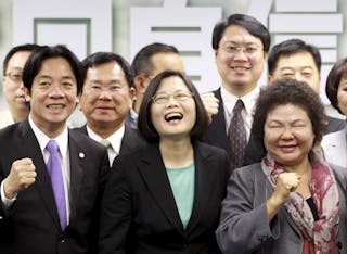 Taiwan's main opposition Democratic Progressive Party (DPP) Chairperson Tsai Ing-wen laughs while party officials prepare to sho