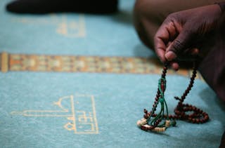 Man Holding Prayer Beads During Friday Prayer