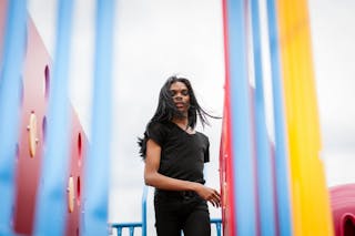 Young man with long hair in playground