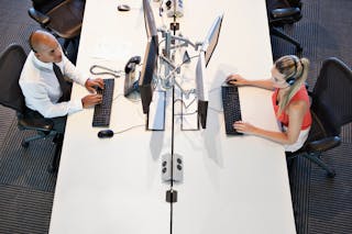 Two people working in office, high angle view