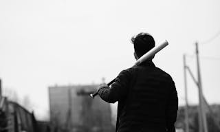 Black White photo of Asian young man outdoors posing at camera