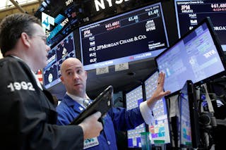 Traders work on the floor of the NYSE