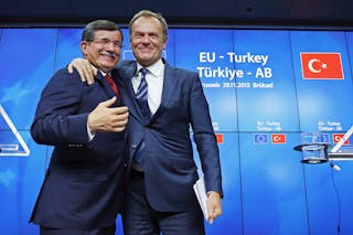 Turkish Prime Minister Ahmet Davutoglu and European Council President Donald Tusk greet each other after a news conference follo