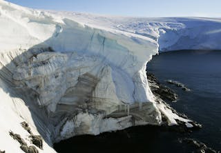 Melting ice shows through at a cliff face at Landsend, on the coast of Cape Denison in Antarctica