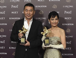 Chen Jianbin and Chen Shiang-chyi pose with their awards at the Golden Horse Film Awards in Taipei