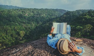 Asian man travel relax in the holiday. sleep relax read books on rocky cliffs. On the Moutain. In Thailand - Image