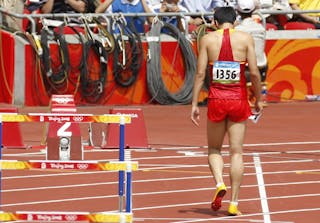 China's Liu Xiang leaves the track after being injured in a men's 110-meter hurdles first round heat during the athletics competitions in the National Stadium  at the Beijing 2008 Olympics in Beijing, Monday, Aug. 18, 2008. (AP Photo/Kevin Frayer)