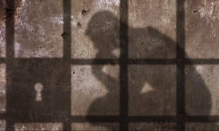 監獄＿坐牢＿Thinking man Shadow Under Jail Bars.