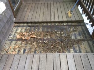 Leaf debris buildup under rooftop deck