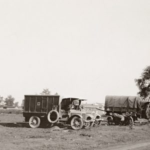 Red cross trucks parked in a field