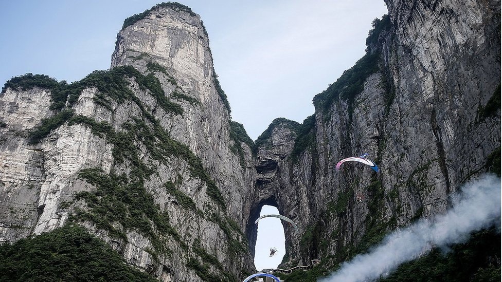 The paraglider rides the paramotor during Heavens Gate Paramotor Air Games on June 26,2019 in Zhang Jiajie,Hunan Province,China