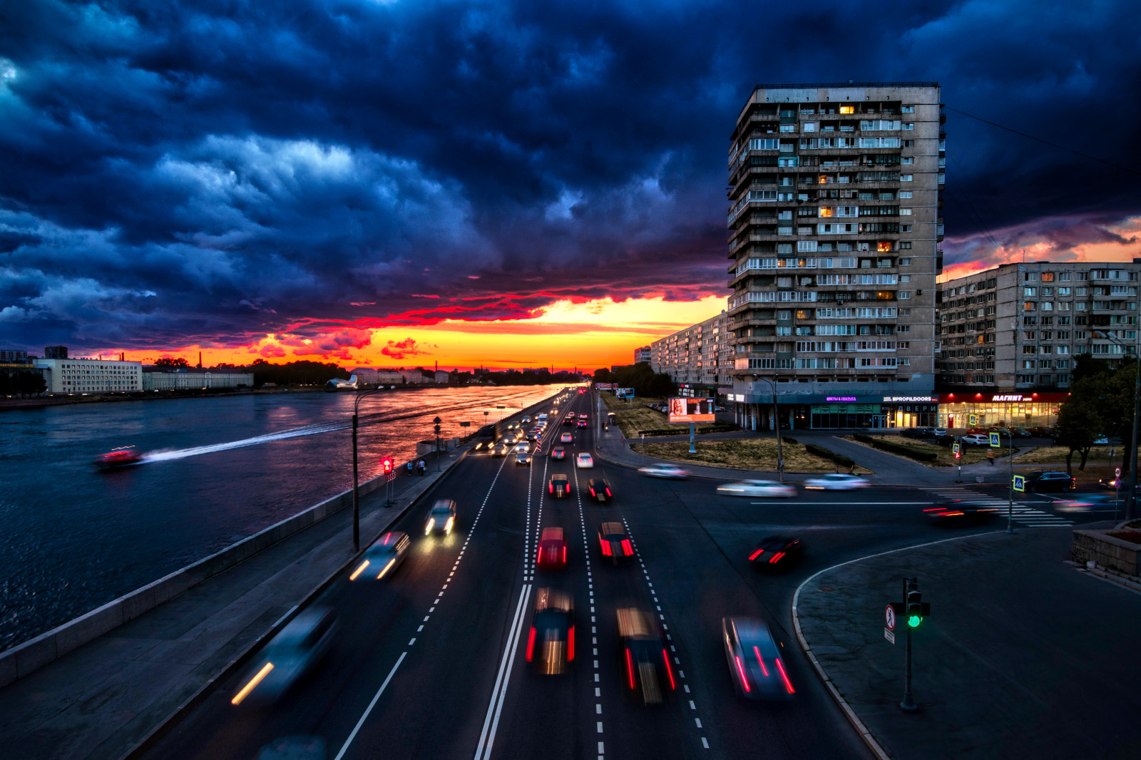 cloud, sky, building, water, car, infrastructure, automotive lighting, lighting, dusk, tower block, architecture, vehicle, street light, cityscape, afterglow, asphalt, road surface, city, road, horizon, metropolitan area, metropolis, landmark, landscape, skyscraper, urban area, human settlement, sunset, bridge, midnight, evening, Freeway, traffic, reflection, night, highway, street, downtown, condominium, nonbuilding structure, tower, mixed use, sunrise, lane, town, skyline, intersection, overpass, ocean, fixed link, commercial building, darkness, headquarters, dawn, junction, transport