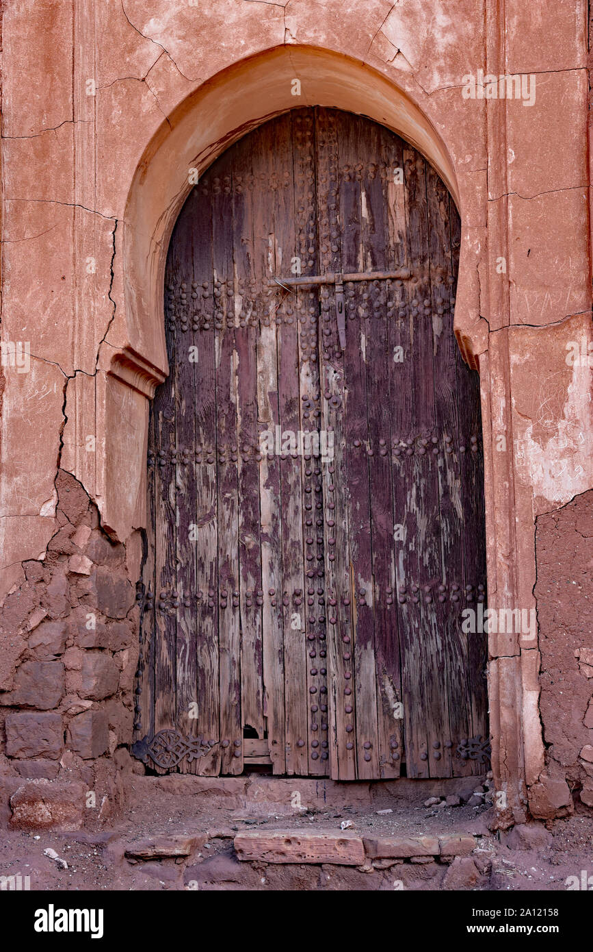 Distressed wooden door in the abandoned and partially ruined el-Glaoui Kasbah of Telouet, High Atlas region, Morocco, North Africa. Stock Photo