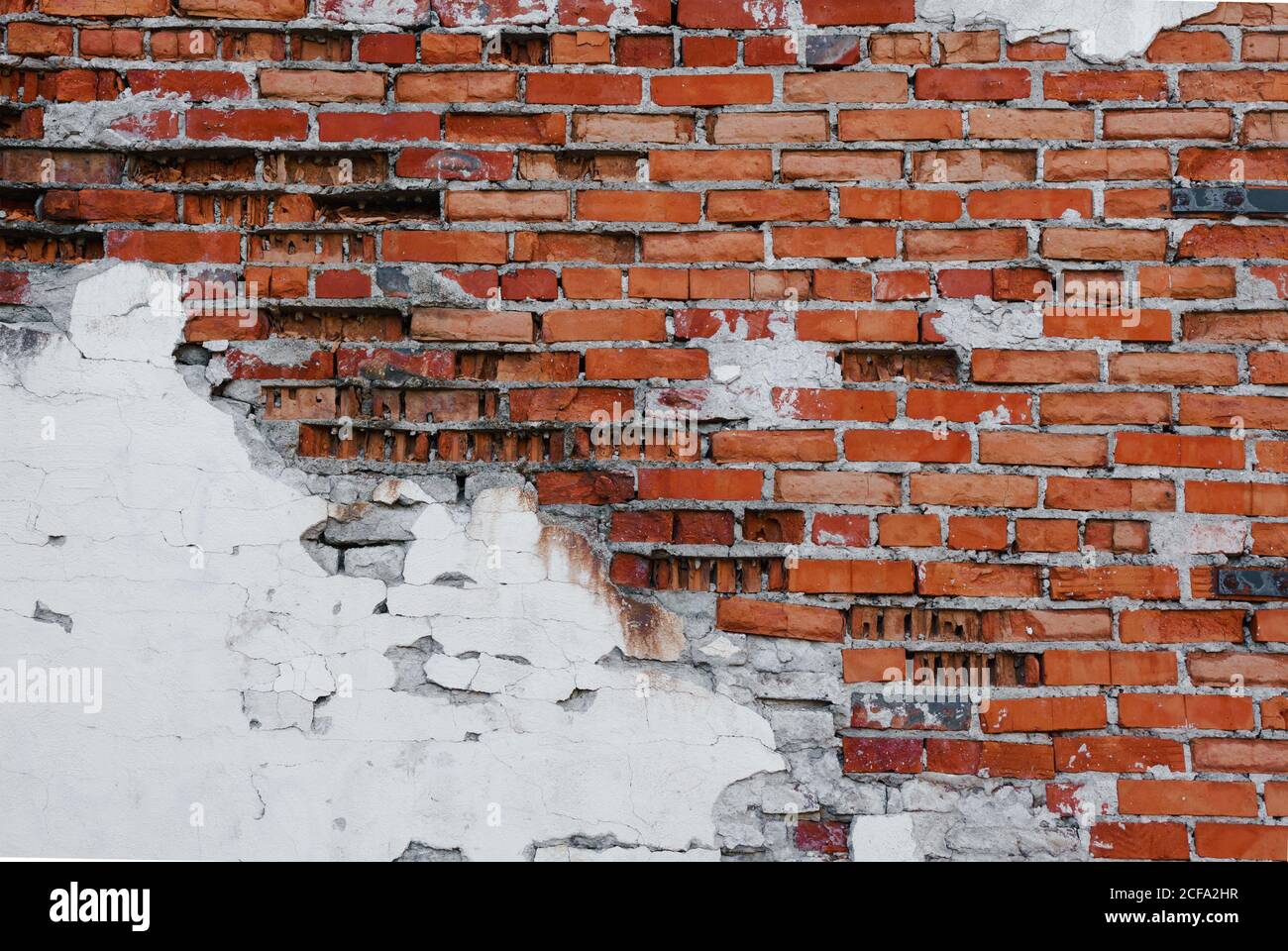 Grunge brick wall with crumbling plaster, brick texture, abstract background Stock Photo