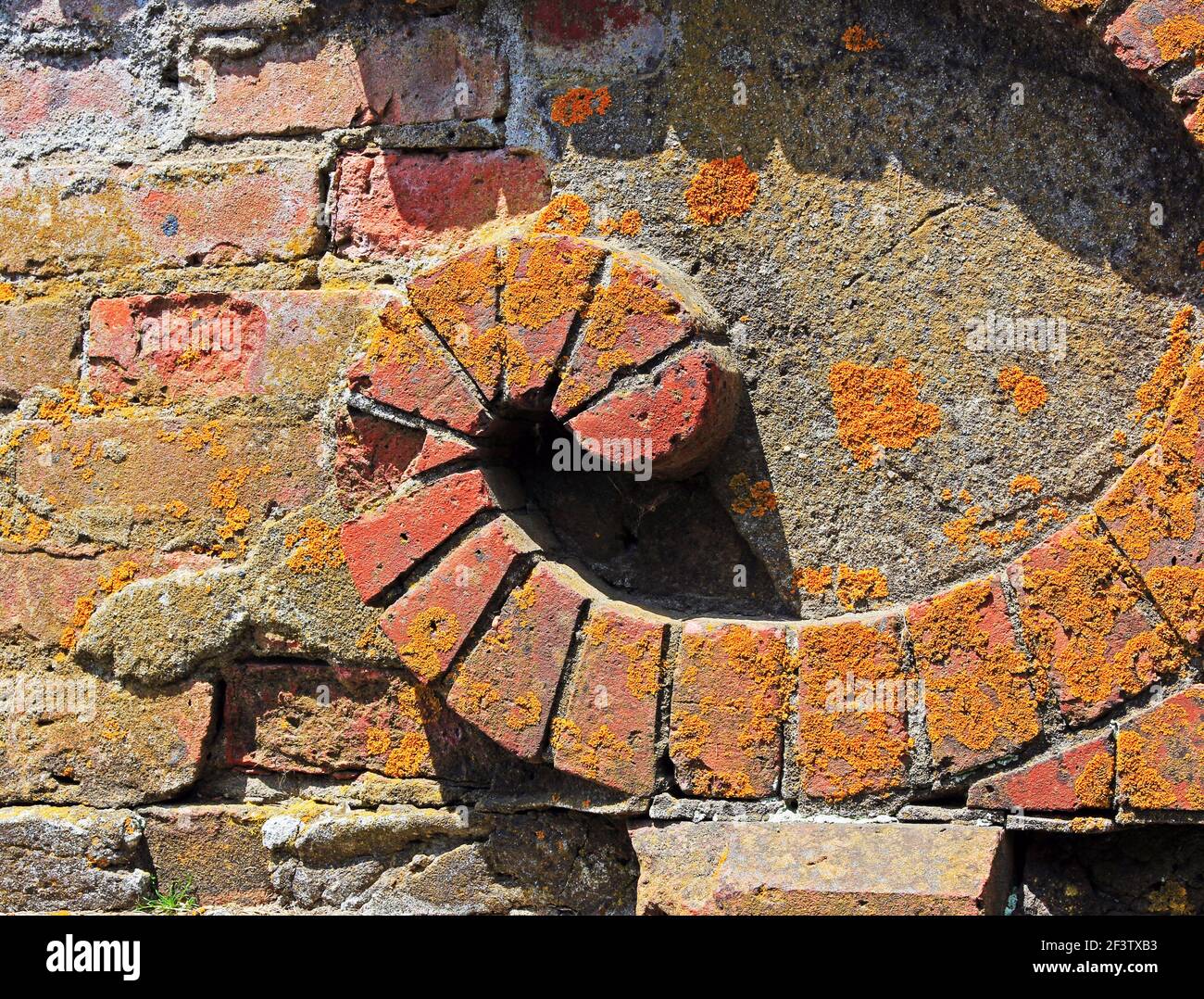 Detail of old brickwork with an ornamental curl. Stock Photo