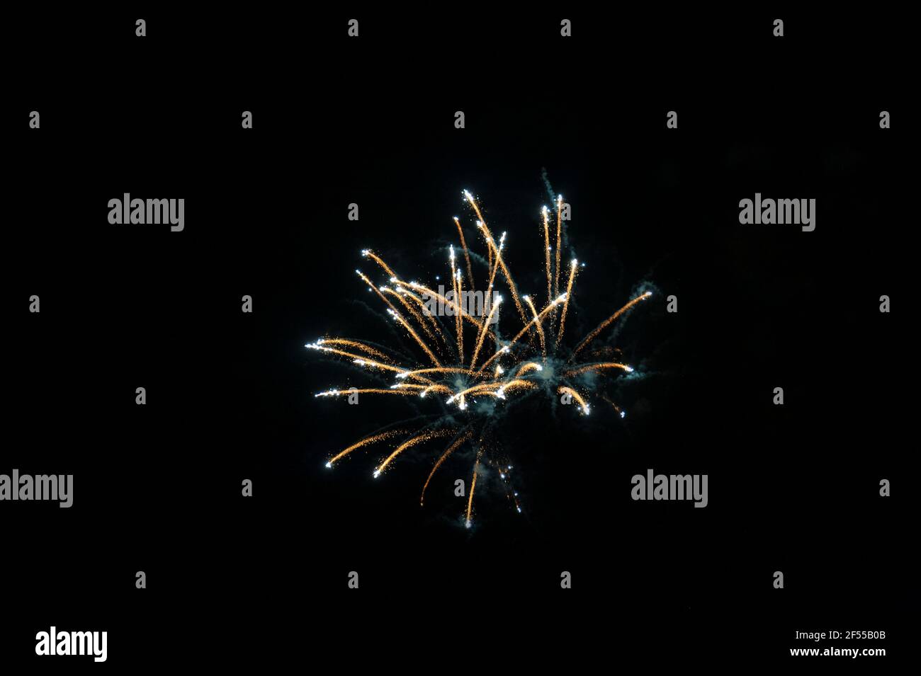 Simple firework display against the night sky, explosive pyrotechnic devices used for celebratory purposes, at the end of parties or festivals Stock Photo